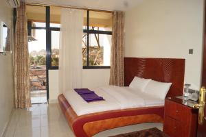 Postel nebo postele na pokoji v ubytování Hotel OK Kampala