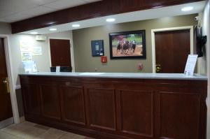 a bar in a hospital with a picture of horses on the wall at Super 8 by Wyndham Louisville/Expo Center in Louisville
