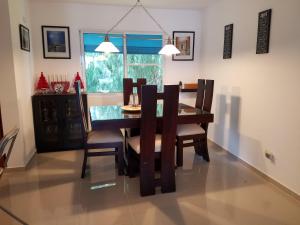 a dining room with a table and chairs at Little Live in Harmony - Santiago in Santiago de los Caballeros