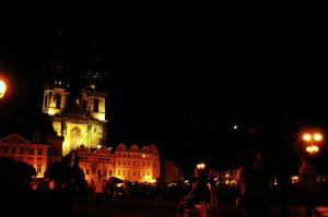 a lit up building with a clock tower at night at Prague Studio Old Town in Prague