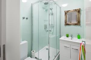 a bathroom with a shower and a toilet and a sink at FeelingLisbon Tejo in Lisbon +84 photos