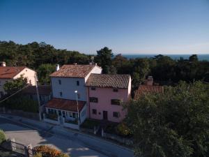 a view of a town with houses and a street at Hotel Aurora Duino in Duino
