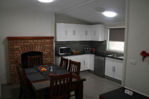 a kitchen with a table and a brick fireplace at 34 on Emily in Seymour