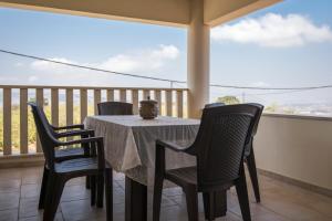 a table and chairs on a balcony with a view at Agrepavli Lapithia in Kallepia