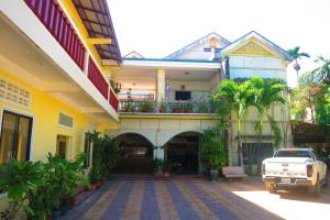 a white truck parked in front of a building at Kampot guesthouse in Kampot