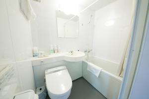 a white bathroom with a toilet and a sink at Yamagata-City AKOYA in Yamagata +2 photos