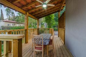 a wooden deck with a table and chairs on it at Pina BaGilboa in Bet Alfa