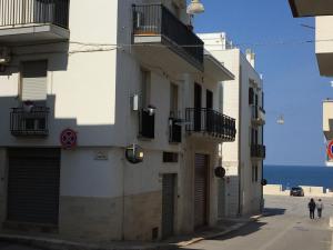 a group of buildings on a street next to the ocean at Profumo d'aMARE in Polignano a Mare