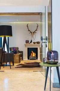 a living room with a fireplace and a table at The Alex Hotel in Freiburg im Breisgau