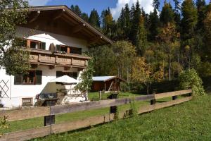 a house with a fence in front of it at Ferienhaus am Gebraweg in Fieberbrunn in Tirol - Saalbach, Leogang, Hochfilzen, Kitzbühel in Fieberbrunn