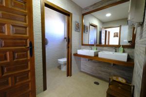 een badkamer met 2 wastafels en een toilet bij Casas de Alisné in Almodóvar del Río