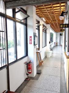 an empty hallway of a building with windows at Old Man Captain in Tainan