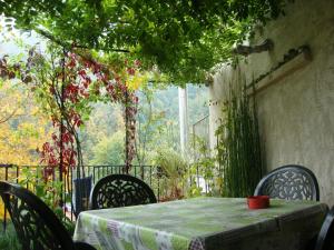 a table and chairs with a tablecloth on a patio at Bed & Breakfast Barba Bertu di Frassino in Frassino