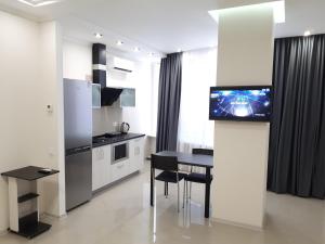 a kitchen with a table and a dining room at IRIS apartments in Odesa
