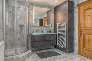 a bathroom with a shower and a sink at Sportchalet Zillertal in Uderns +14 photos