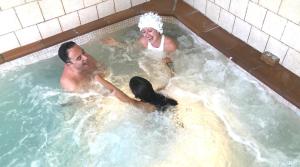 a man and a woman in a hot tub at La Senda de los Caracoles - Spa in Grado del Pico