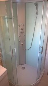 a shower with a glass door in a bathroom at Karmabnb in Cala Gonone