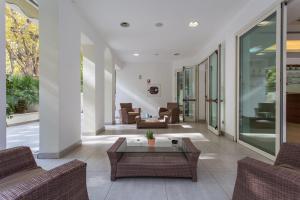 a living room with couches and a coffee table at Wally Residence in Rimini