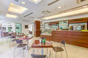 a restaurant with tables and chairs and a counter at Wally Residence in Rimini