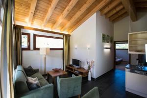 a living room with a couch and a table at Chasa Miramont in Samnaun