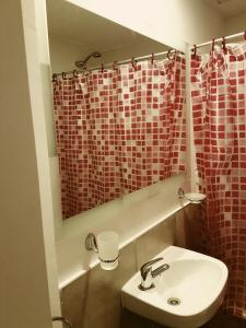 a bathroom with a sink and a shower curtain at Apartamento La Plata in La Plata