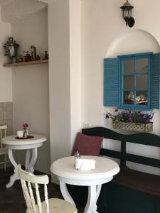 a table and two chairs and a sink in a room at Hotel Delisi in Tbilisi City