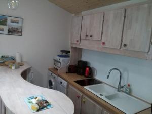 a kitchen with a sink and a counter top at Les Chênes Bleus in Sainte-Marie-de-Ré