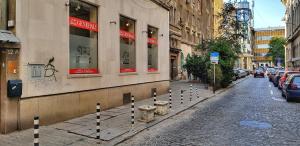 a cobblestone street with poles in front of a building at Apartment 11 in Sofia