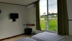 TV a/nebo společenská místnost v ubytování Muangway Garden Ville