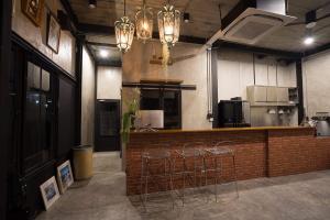 een keuken met een bar met krukken in een kamer bij VILLA23 Residence in Bangkok