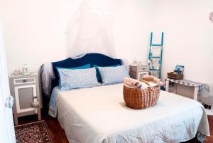 a bedroom with a bed with a basket on it at Vistazzurra B&B in Ancona