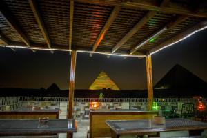 a restaurant with a view of the pyramids at night at Guardian Guest House in Cairo