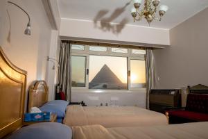 a hotel room with a view of the pyramids at Guardian Guest House in Cairo