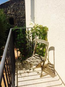 a wooden chair sitting on a staircase next to a building at Le Antiche Mura in Semproniano