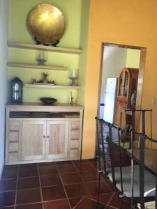 a room with a kitchen with a counter and a refrigerator at Casa Constelaciones in Tepoztlán