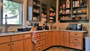 a kitchen with a stove, sink, and cabinets at Bunk & Brew Historic Lucas House - Hostel in Bend