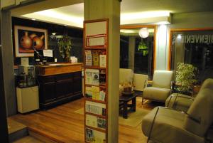 a salon with a waiting room with chairs and a counter at Complejo Sakura in Villa Gesell