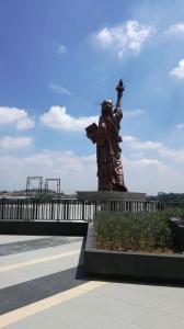a statue of a man with a torch on a bridge at i-city i-soho in Shah Alam