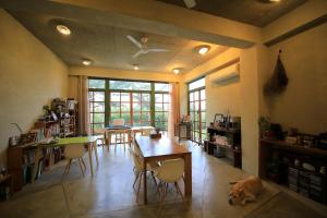 a living room with a table and a dog laying on the floor at Country Living Home Stay in Jian