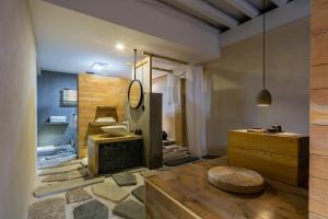 a bathroom with a sink and a toilet in a room at Shangri-La Karesansui Hotel in Shangri-La