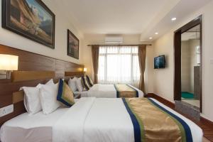 Letto o letti in una camera di Oasis Kathmandu Hotel