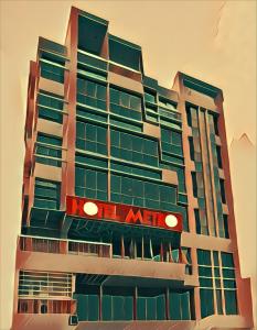 un edificio con un cartel en el costado en Hotel Metro International en Sylhet