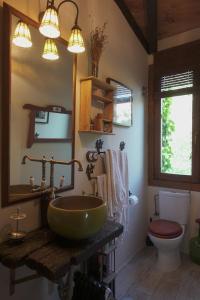 a bathroom with a green sink and a toilet at Las Horas Perdidas in Manzanares el Real +27 photos