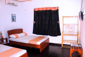 Postel nebo postele na pokoji v ubytování D'Villa Guest House