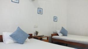 Postel nebo postele na pokoji v ubytování D'Villa Guest House