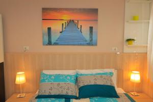 a painting of a pier on the wall above a bed at Apartment Centar in Pula
