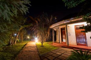 a house at night with a pathway leading to it at Arusha Planet Lodge in Arusha