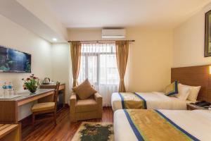 Letto o letti in una camera di Oasis Kathmandu Hotel