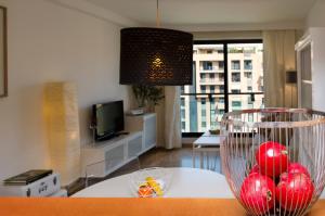 a living room with a table with red balls in a bowl at ApartUP Francia Views in Valencia