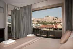 a bedroom with a bed and a large window at Unique Acropolis View in Athens